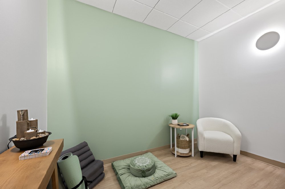 Serene wellness room with yoga equipment, meditation pillows, and a Zen garden